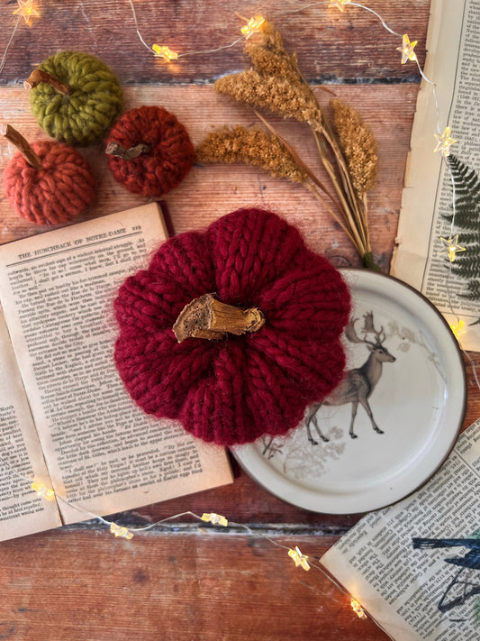 Tiny knitted pumpkin vampire red with gold stalk