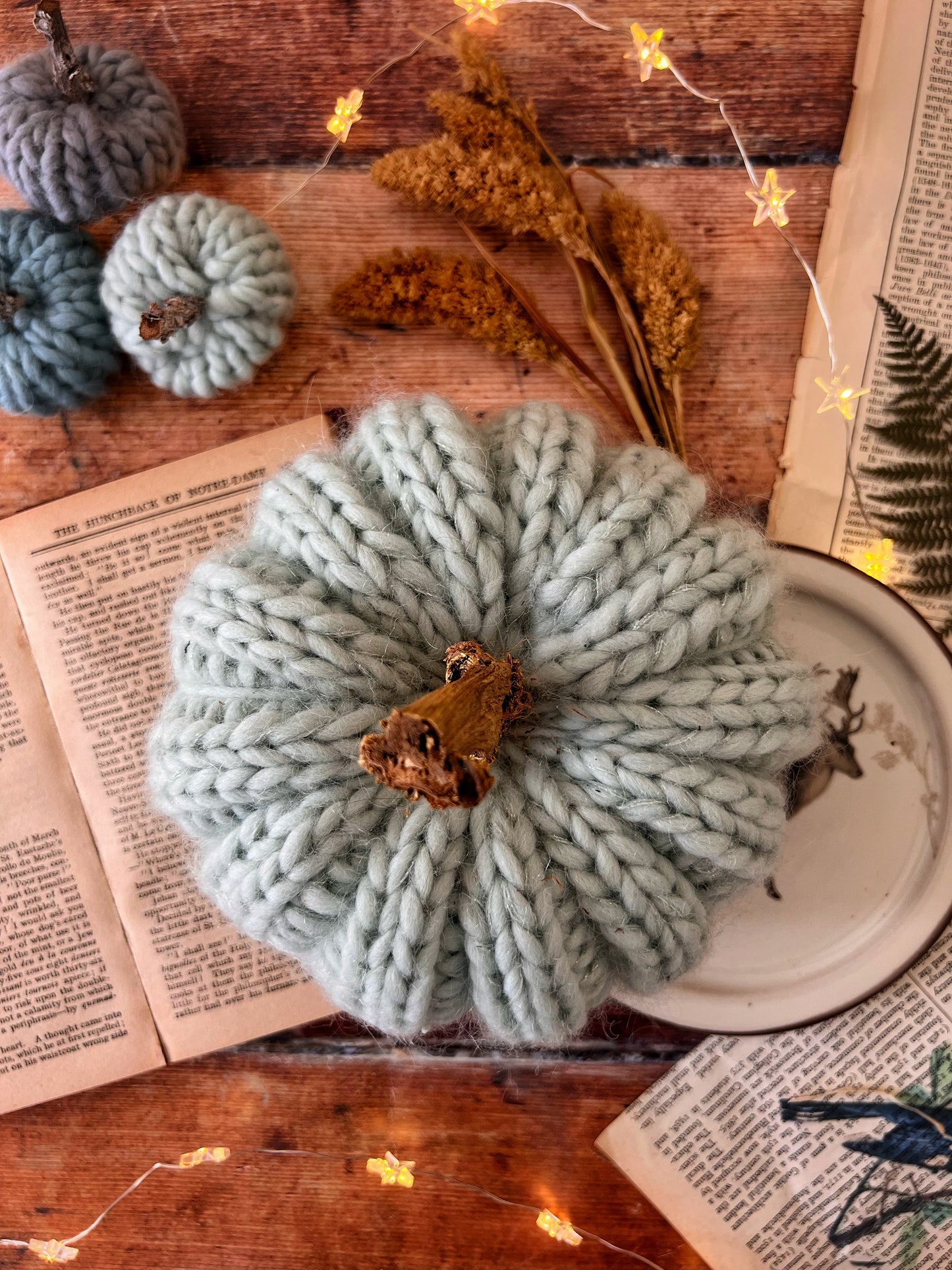 Small knitted pumpkin pale mint with gold stalk