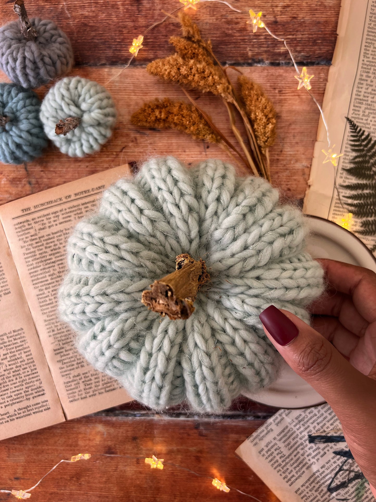 Small knitted pumpkin pale mint with gold stalk